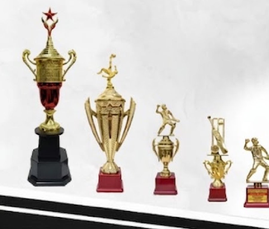 Row of gold fiber trophies and cups in various sizes